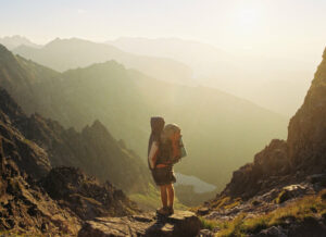 Ein Mann beim Backpacking steht in den Bergen